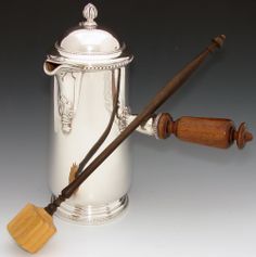 an antique silver "chocolate pot" for serving drinking chocolate and molina to stir the hot drink with