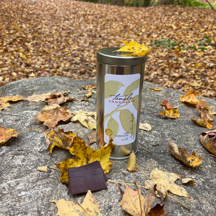 9 oz tin of luxury handmade hot chocolate mix in an outdoor setting
